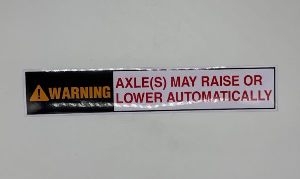 Axle may raise or lower automatically sticker